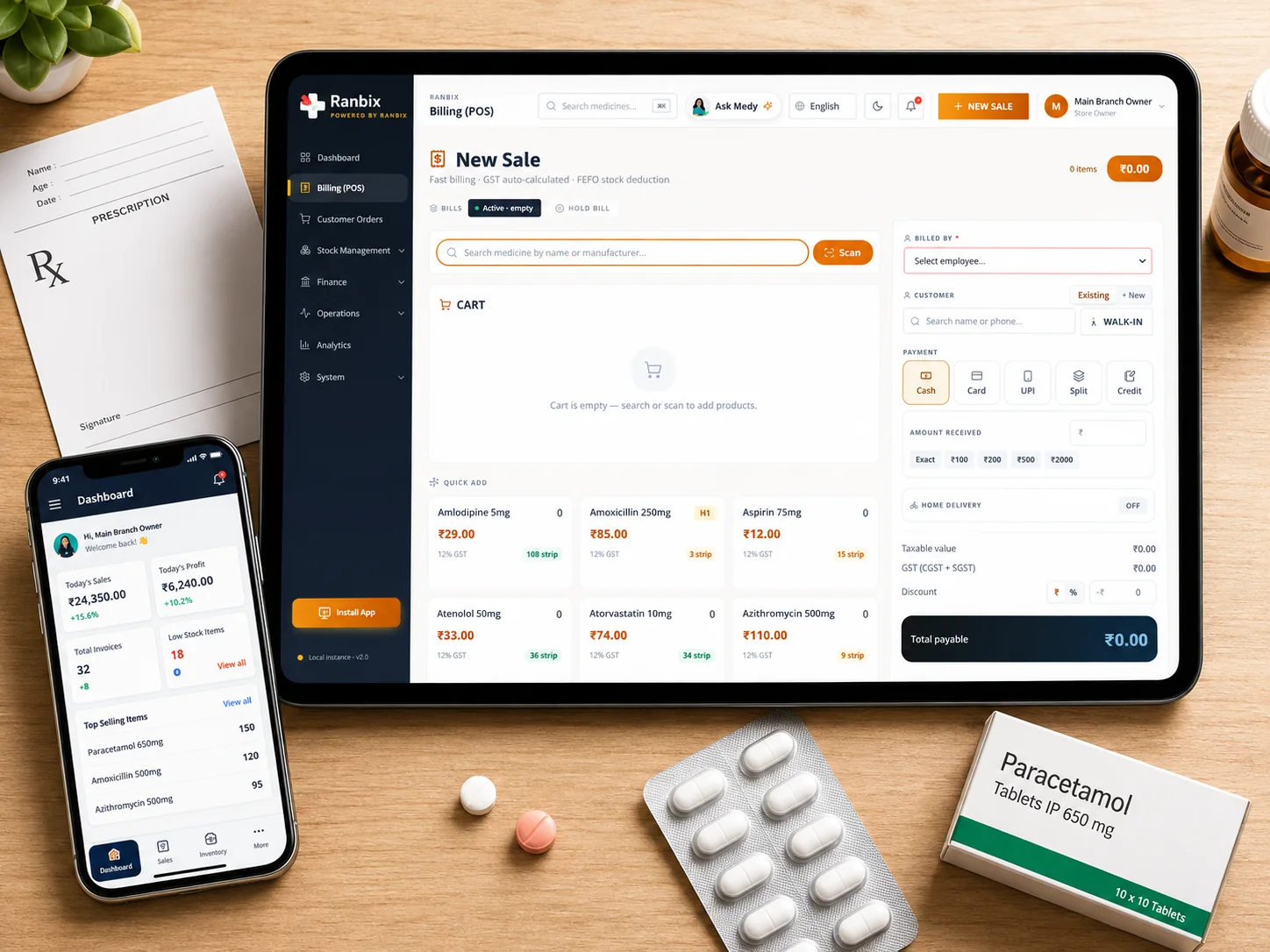 Ranbix billing open on a tablet at a pharmacy counter, beside a prescription pad, a blister strip and a box of paracetamol